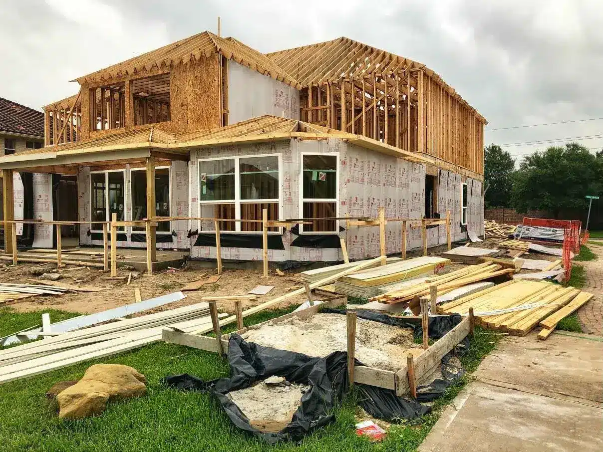 Custom home under construction showing framing and build milestones